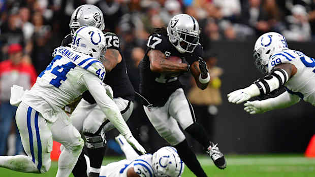 Nov 13, 2022; Paradise, Nevada, USA; Las Vegas Raiders wide receiver Davante Adams (17) runs the ball against Indianapolis Colts cornerback Kenny Moore II (23) defensive tackle DeForest Buckner (99) and linebacker Zaire Franklin (44) during the first half at Allegiant Stadium.